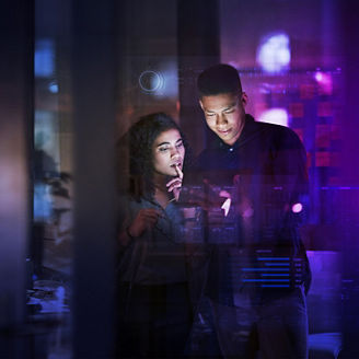 Workers using AI on a digital tablet in the office at night