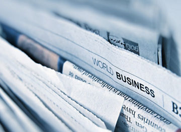 World business page in newspaper stack