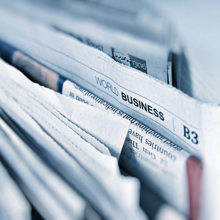 World business page in newspaper stack
