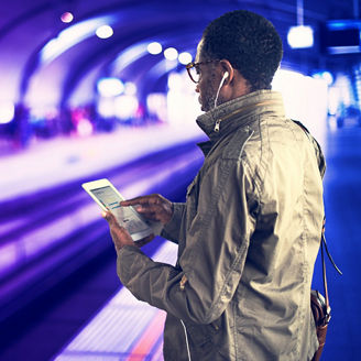 young man looking at his phone at a station