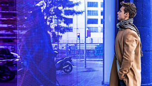 Man looking at window with reflection