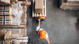 Young man working at a warehouse with boxes, Young man working at a warehouse with boxes
