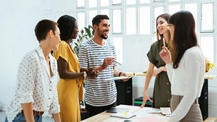 five-people-discussing-business-under-building