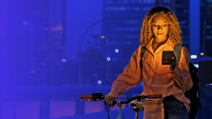 Woman with bike looking at phone