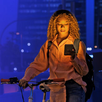 Woman with bike looking at phone